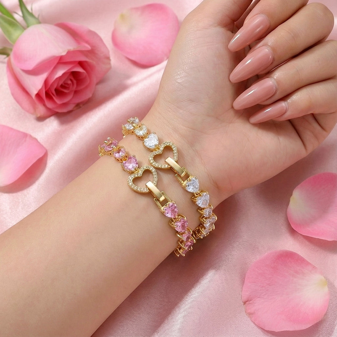 Gold bracelet and silver bracelet with pink stones on a hand with pink roses and petals in the background